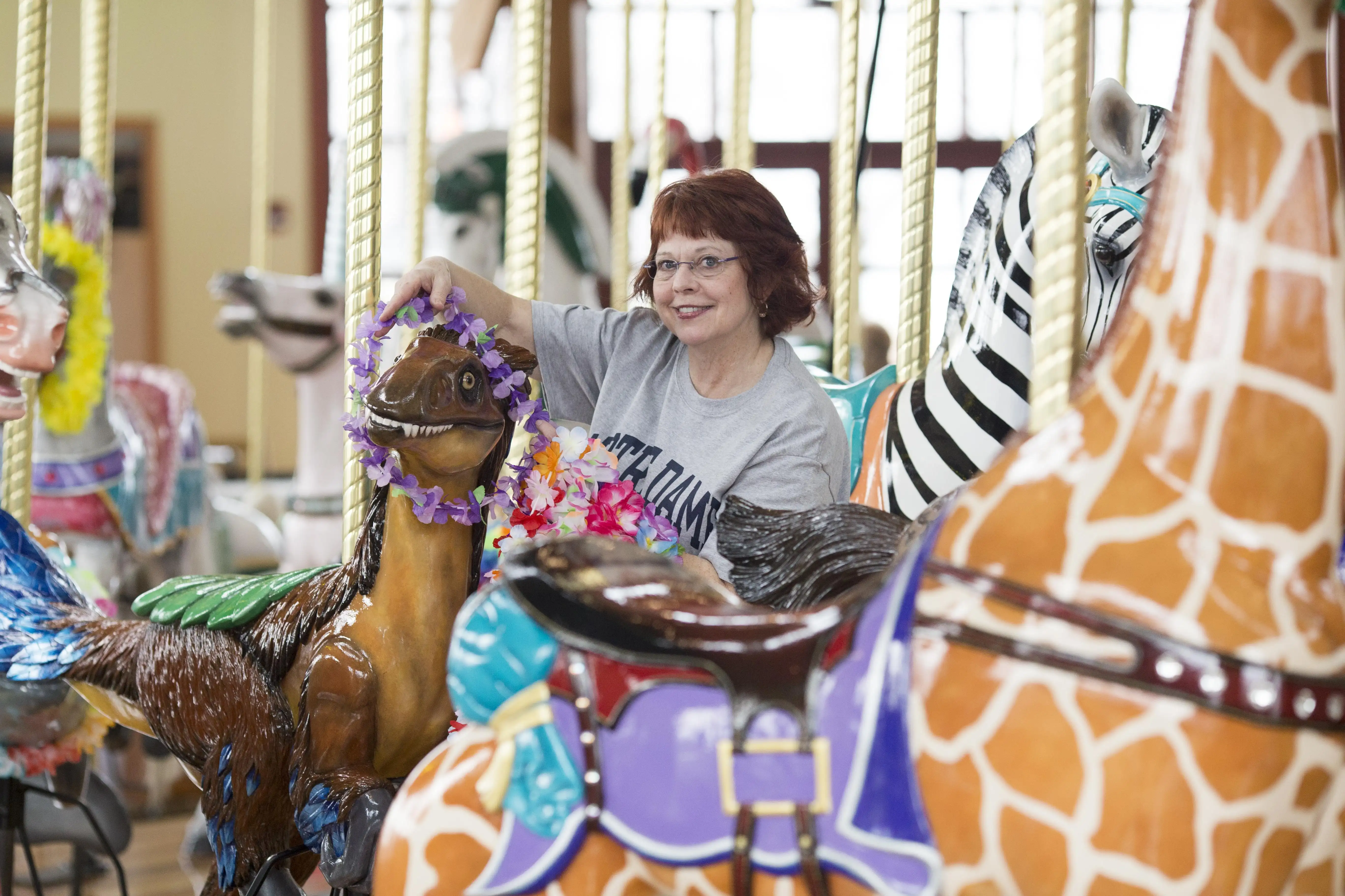 A volunteer decorating the carousel.